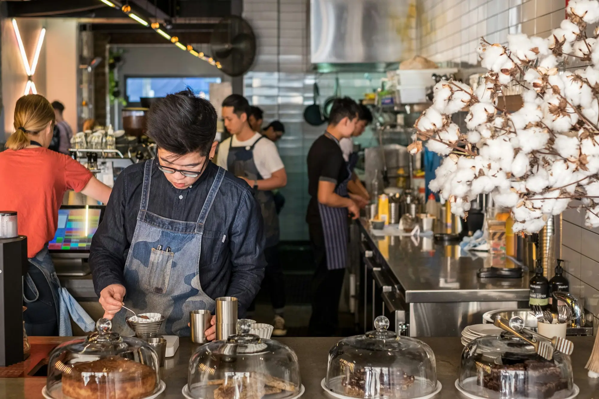 Busy Sydney café counter with the owner preparing orders