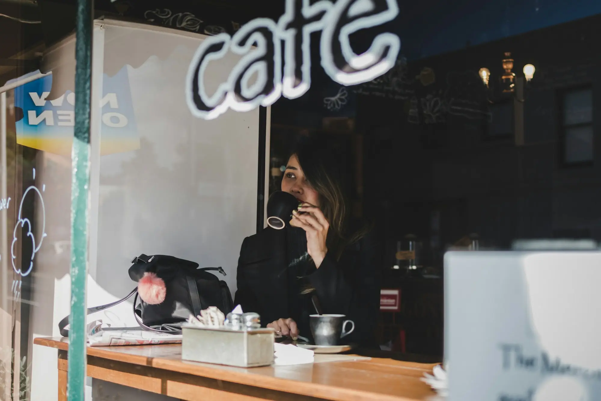 Café owner reading paperwork at the counter after closing in Hobart